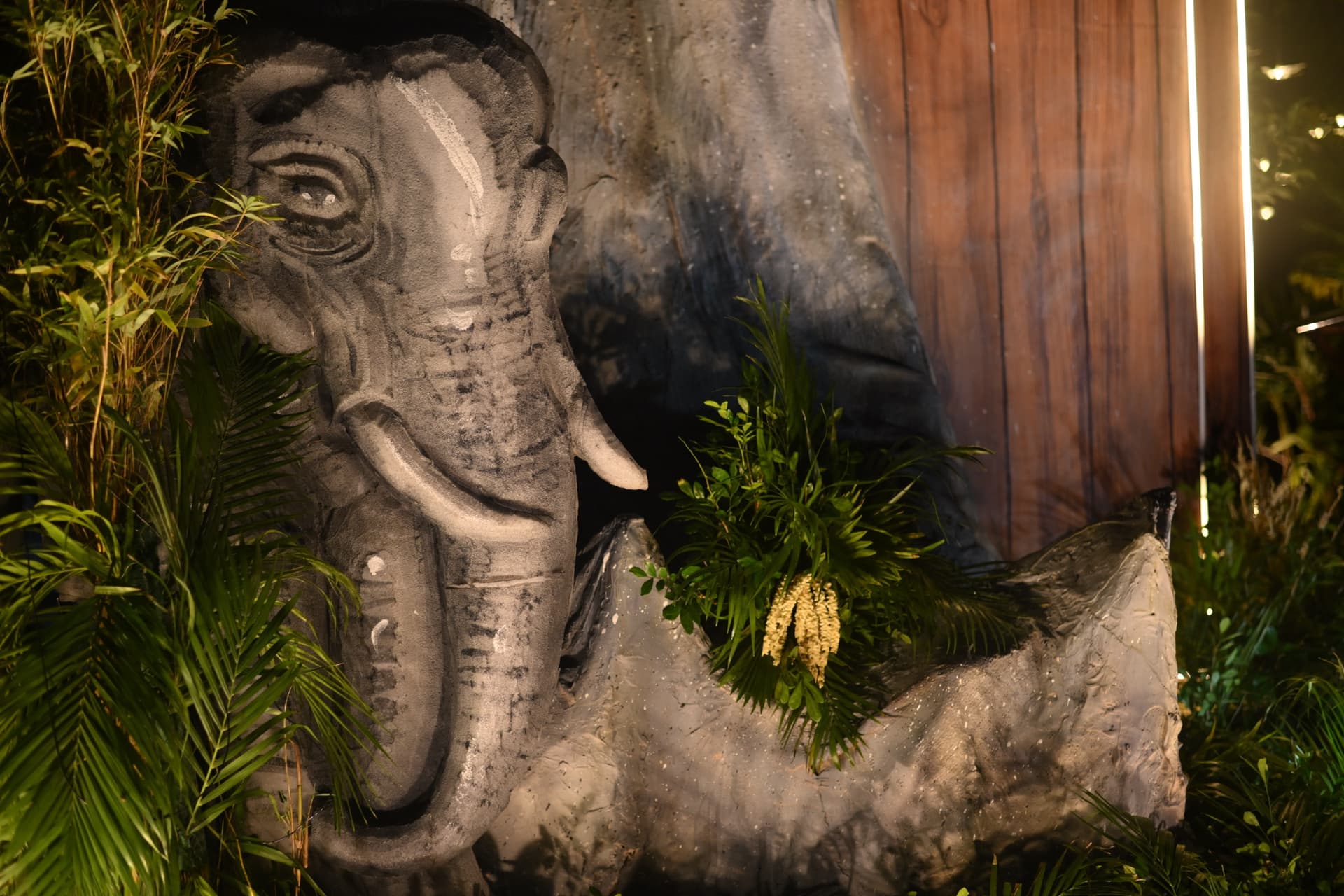 Close-up detail of a carved elephant sculpture with ambient lighting